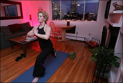 Julie Ravech, a 34-year-old marketing vice president for an investment firm, practiced yoga in her Back Bay condo.